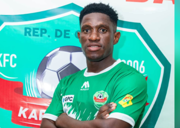 Haschou Kerrido pose avec le maillot de Karfamoriah FC après la signature de son contrat en provenance de l'AS Kaloum.